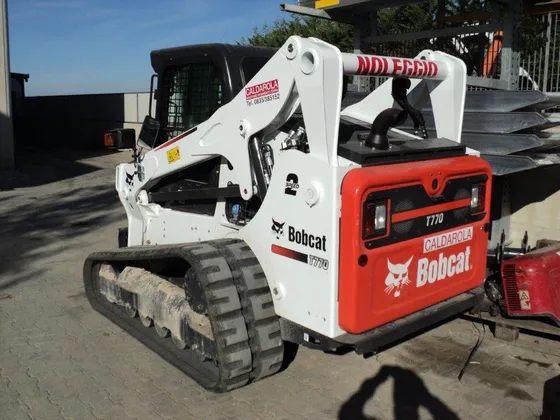 Rear and side view of a Bobcat T770 compact track loader in a yard; the T770 badge is visible.