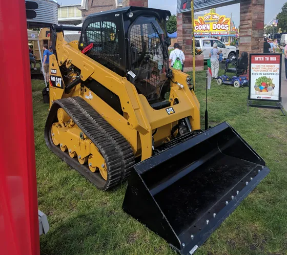 Caterpillar 259D compact track loader with an enclosed cab and bucket on display at the Iowa State Fair.
